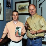 From left, Trey Gaines, Director of the Bartow History Museum, and Joe Head, local historian, author and tour guide, show off historical items in the museum.