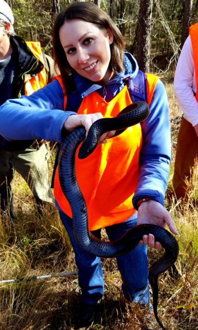 Erin Zaballa holding a black snake 