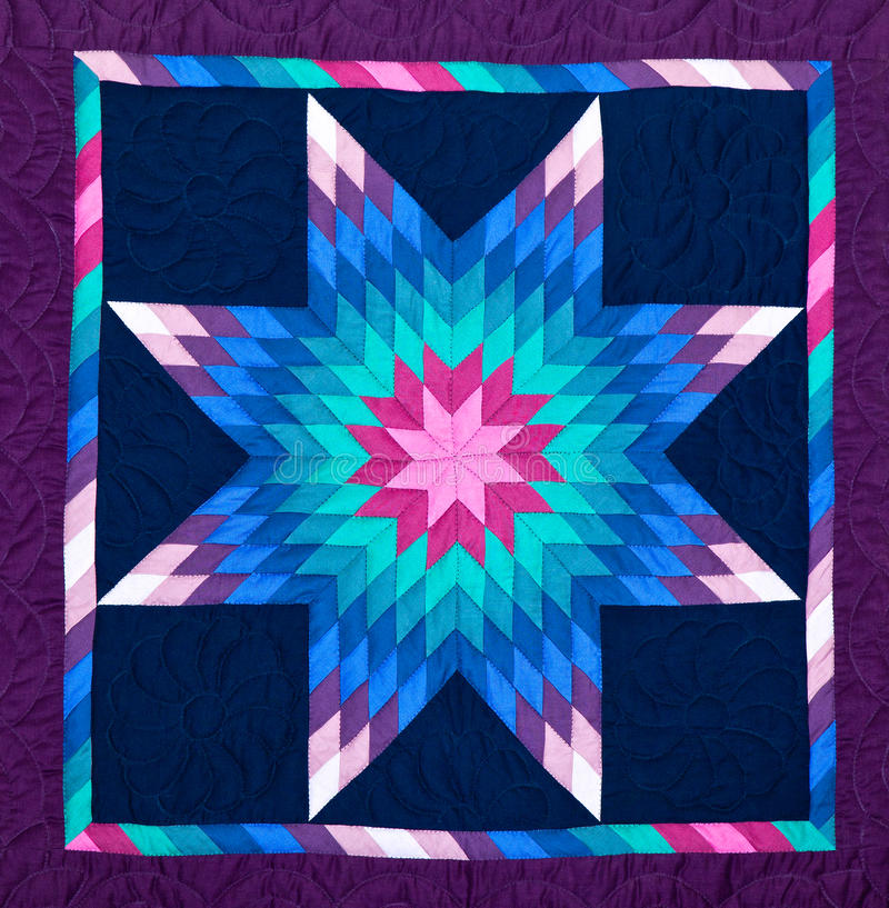 Pink, purple, and blue amish quilt, in star pattern